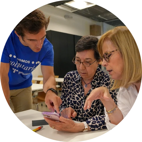 Tres personas comparten una actividad en un smartphone en Reconectados, de Fundación Telefónica